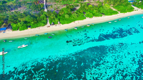 Shoreline of a tropical island in the Maldives and view of the I