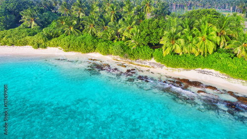 Shoreline of a tropical island in the Maldives and view of the I