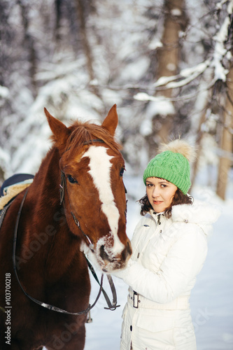 beautiful girl and horse in winter