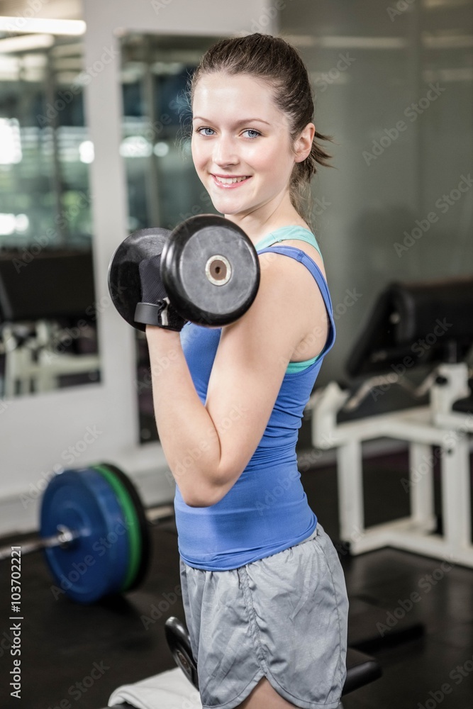 Fit woman lifting dumbbell Fit woman lifting dumbbell