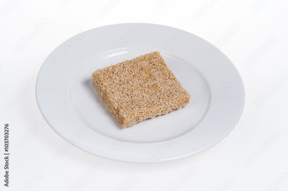 peanut candy on the plate isolated on white background peanut candy on the plate isolated on white background