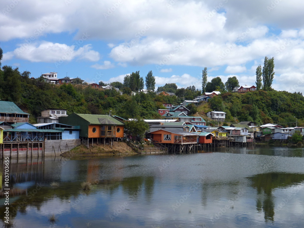 colorful palafotos houses on woodel columns in chiloe island