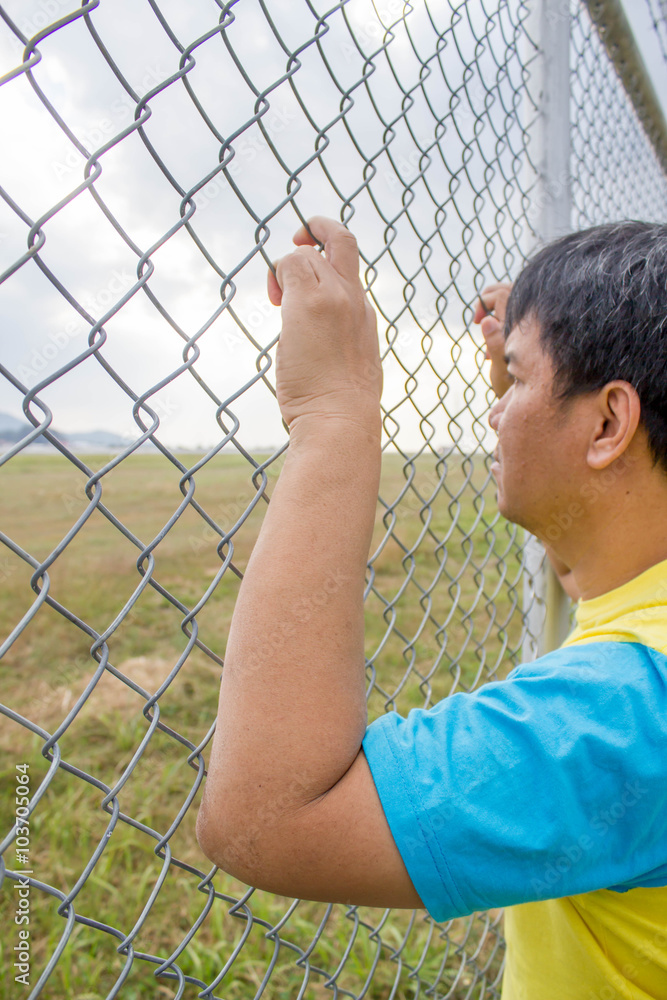 hand holding on chain link fence hand holding on chain link fence