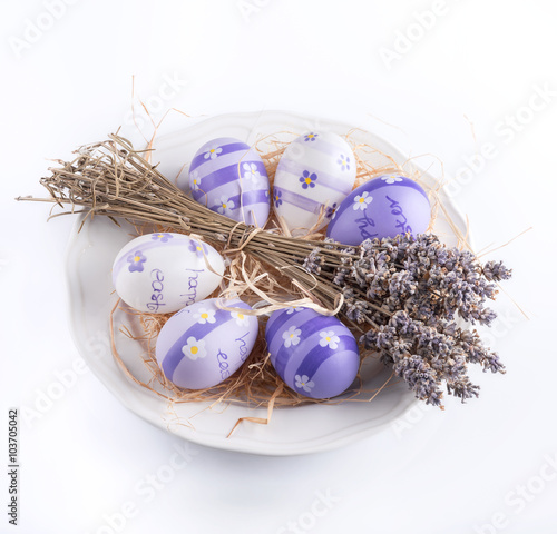 Easter background. Dry lavender and easter eggs on a white background.