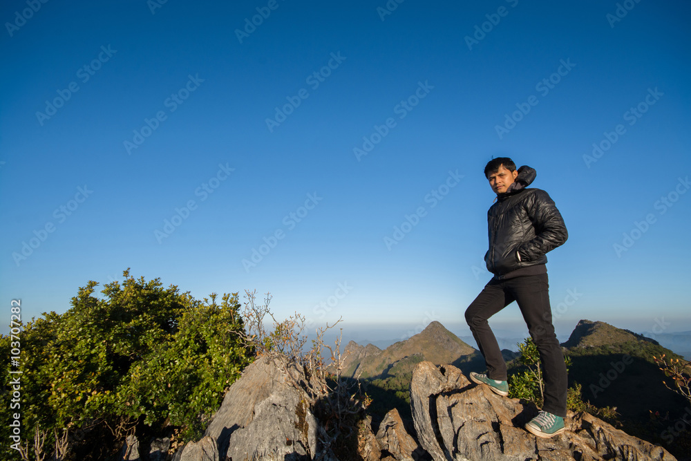 Mountain top with young southeast asian man standing