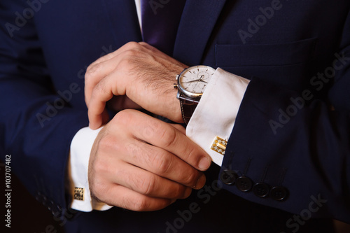 Bild auf Leinwand Mans hands with cufflinks and clocks. Elegant gentleman clother