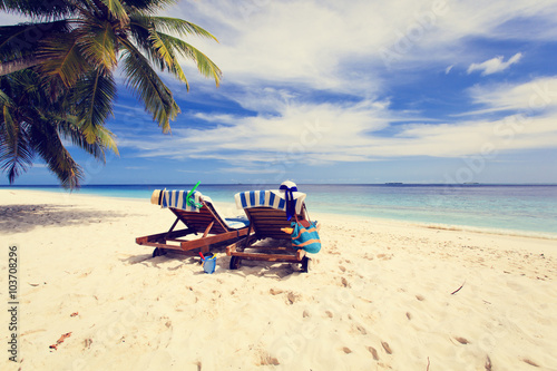 Fototapeta Naklejka Na Ścianę i Meble -  Two chairs on the tropical beach