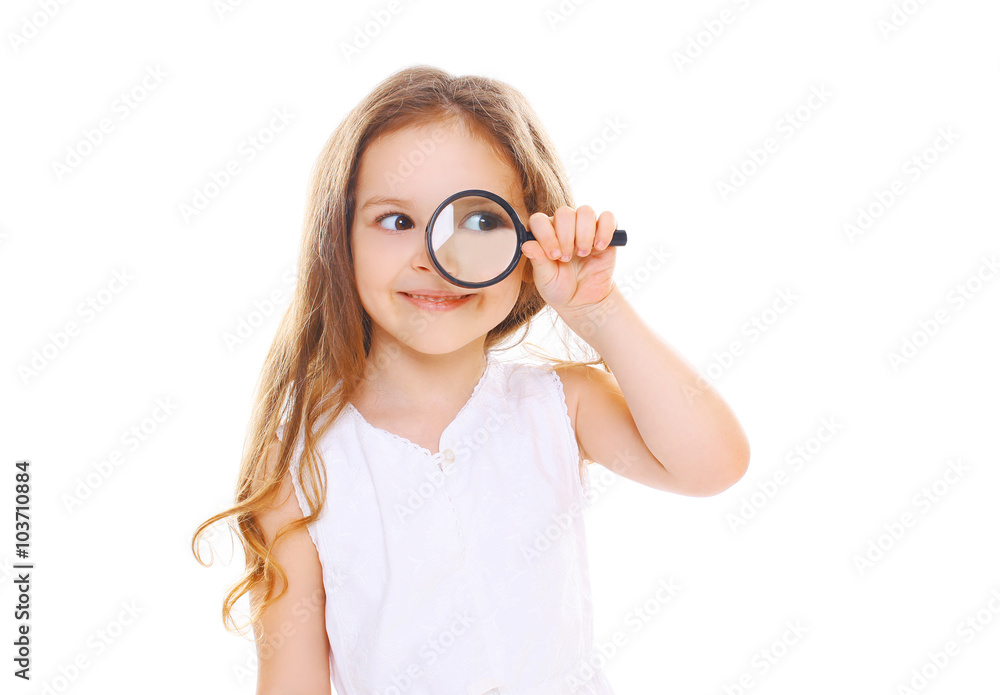 Little girl child looking through a magnifying glass on white ba Little girl child looking through a magnifying glass on white ba