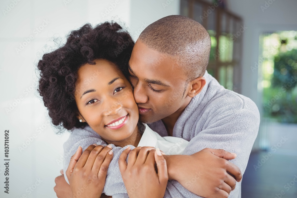 Happy couple hugging in the kitchen Happy couple hugging in the kitchen