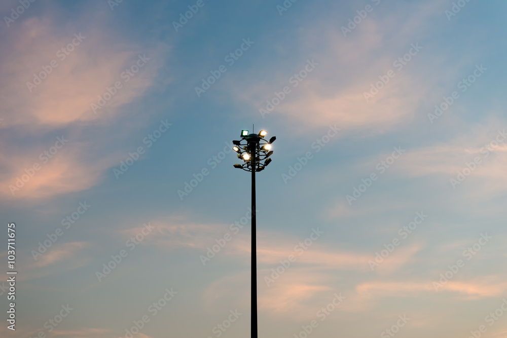 Sport lights post in public garden with sunset