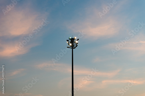 Sport lights post in public garden with sunset