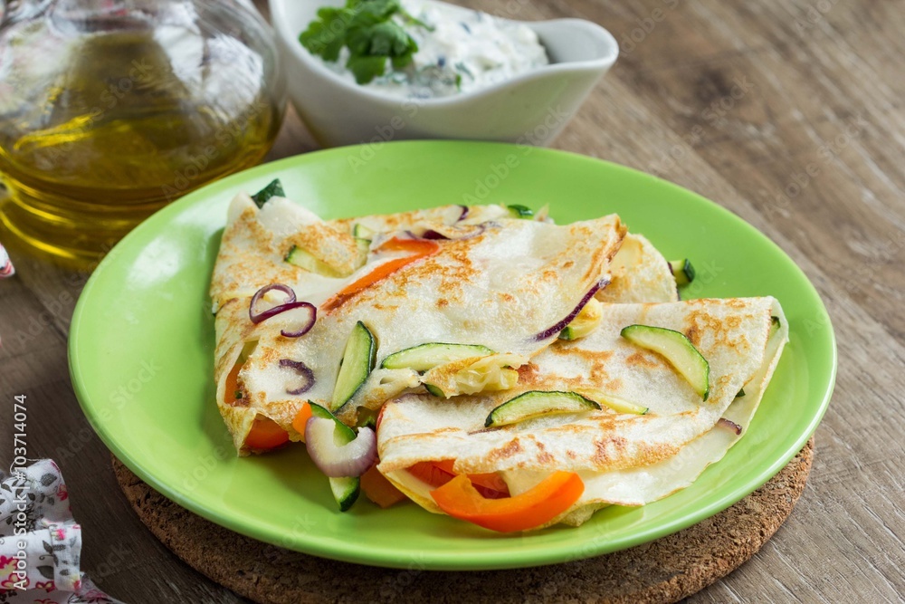 Thin pancakes stuffed with vegetables and greek sauce, crepes