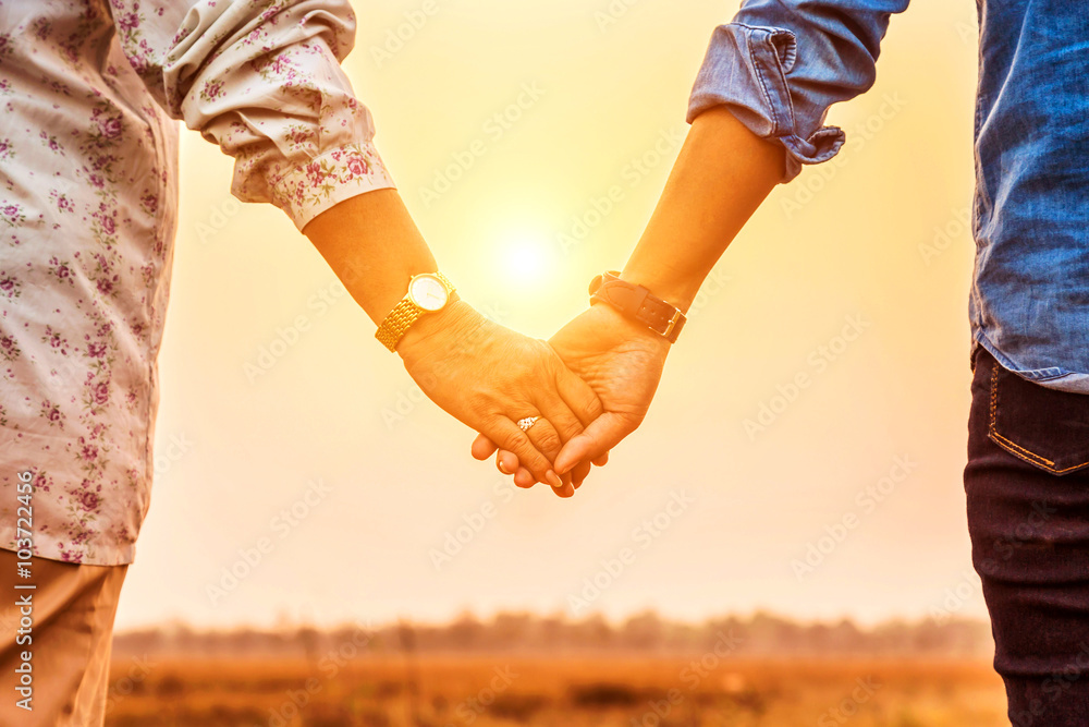 mother holding hand her daughter in sunset . mother holding hand her daughter in sunset .