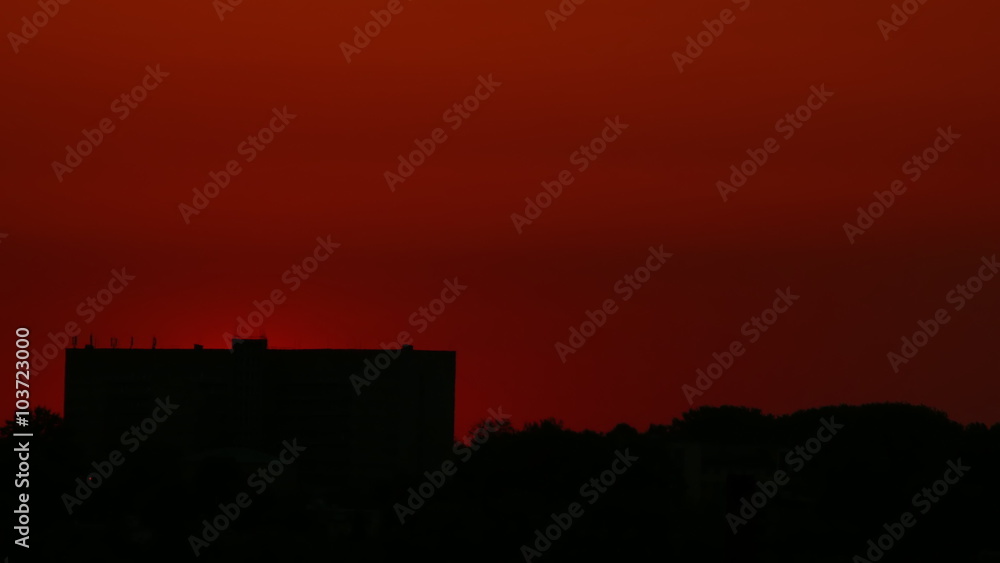 The sun rises up from behind the building in timelapse. 4k UltraHD 3840x2160. The sun rises up from behind the building in timelapse. 4k UltraHD 3840x2160.