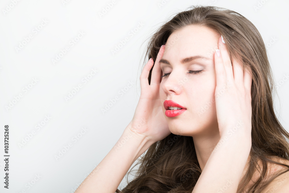Beautiful woman holds a head, suffering from a headache. migraine Beautiful woman holds a head, suffering from a headache. migraine