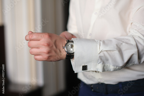 Man in white shirt wears watches