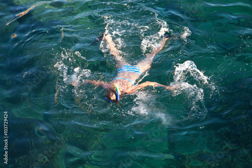 Young woman snorkeling in tropical lagoon