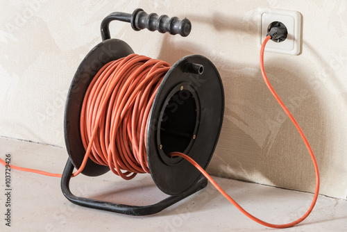 Long orange electrical extension cord