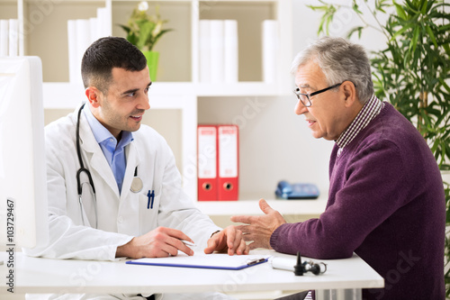 Doctor listening to patient explaining his painful