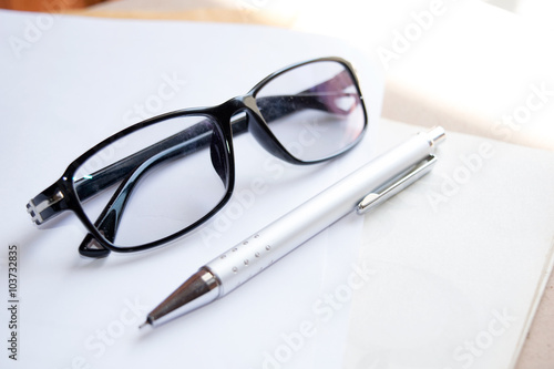 Glasses and pen on notebook - Soft light style