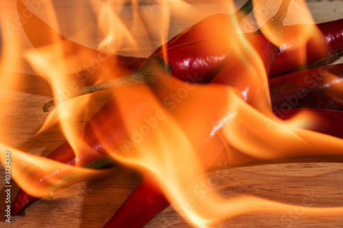 pile of burning red chili on the wood background