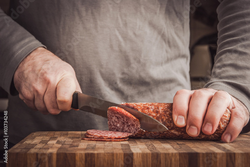Man cutting sausage