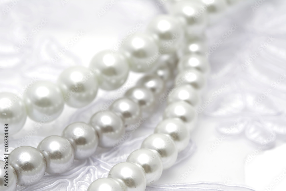 Pearl beads strings on white lace Pearl beads strings on white lace