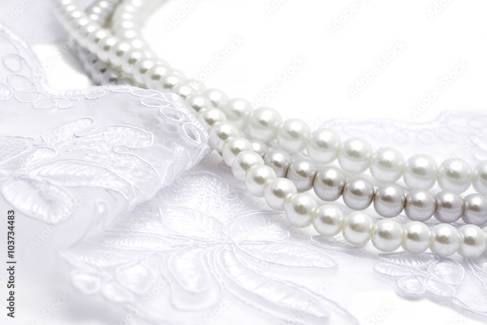 Pearl beads strings on white lace Pearl beads strings on white lace