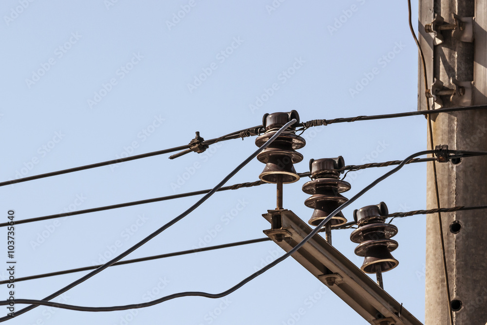ceramic insulators electric current with wires on a background blue sky ceramic insulators electric current with wires on a background blue sky