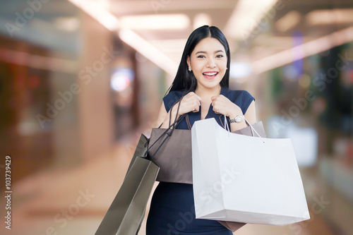 Beautiful young woman with shopping bags isolated on department