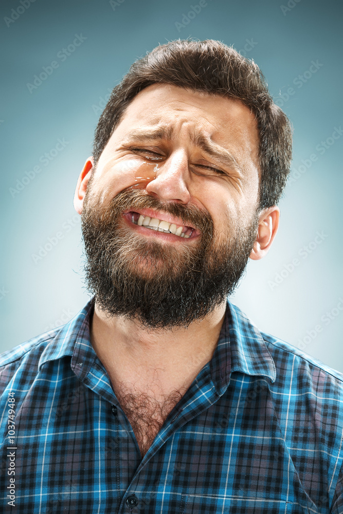 Obraz premium The crying man with tears on face closeup