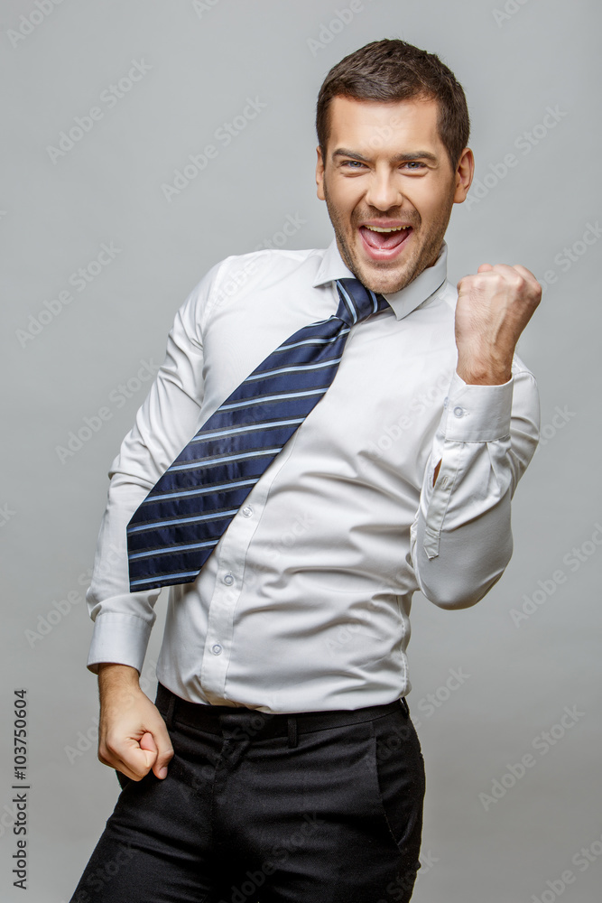 Handsome stylish businessman on grey background Handsome stylish businessman on grey background