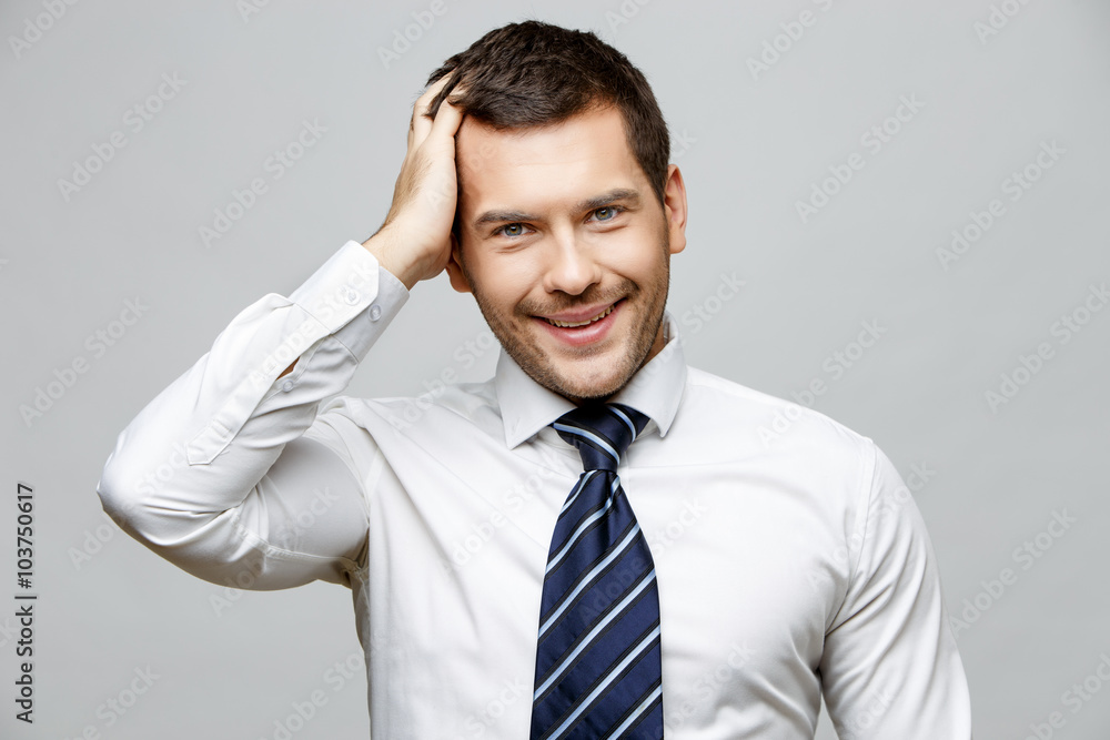 Handsome stylish businessman on grey background Handsome stylish businessman on grey background
