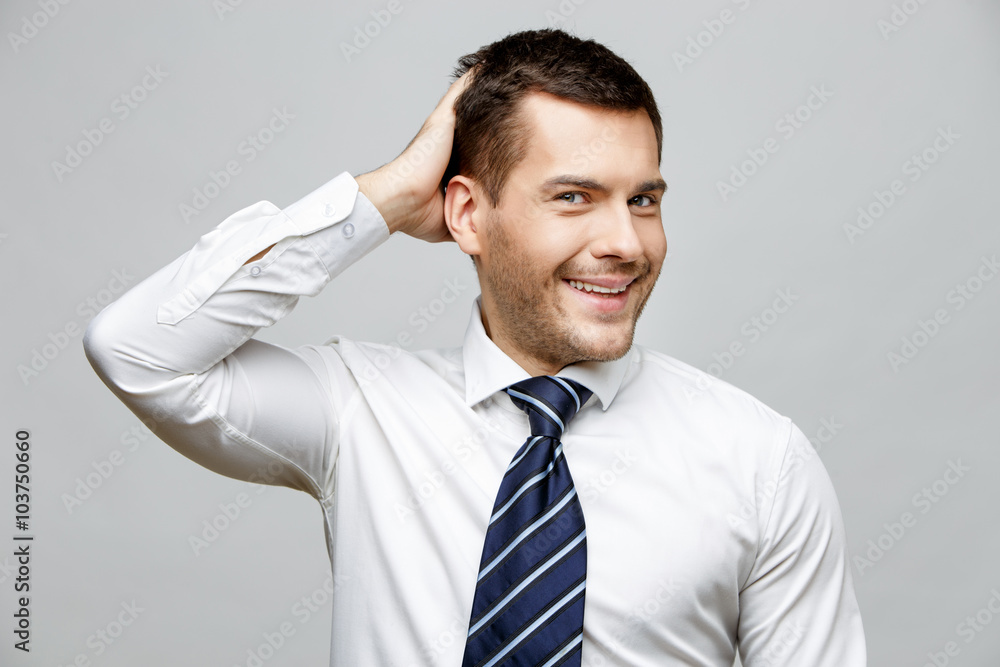 Handsome stylish businessman on grey background Handsome stylish businessman on grey background