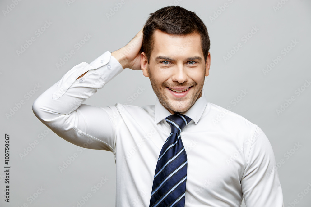Handsome stylish businessman on grey background Handsome stylish businessman on grey background