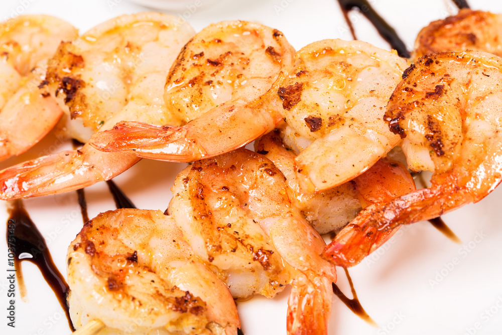 Delicious grilled shrimps on skewers. Delicious grilled shrimps on skewers.