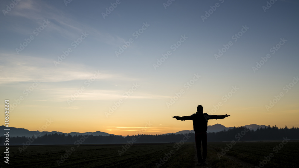 Silhouette of a man standing in beautiful landscape