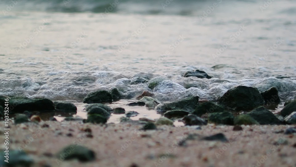 Sea surf at beach with stone on sand Sea surf at beach with stone on sand