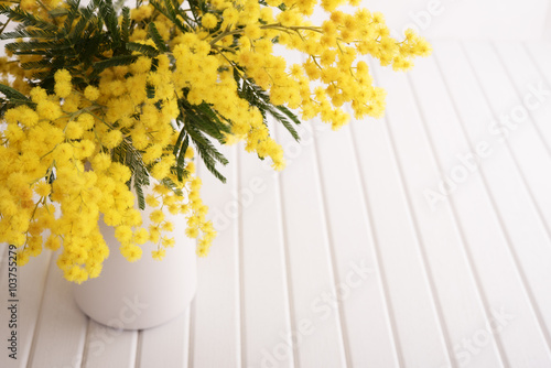 Vase with mimosa flowers photo