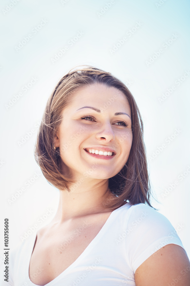 Closeup portrait of Caucasian woman girl in white tshirt looking away with messy long hair bob on sunny windy day outdoor, bright high key, hipster style Closeup portrait of Caucasian woman girl in white tshirt looking away with messy long hair bob on sunny windy day outdoor, bright high key, hipster style