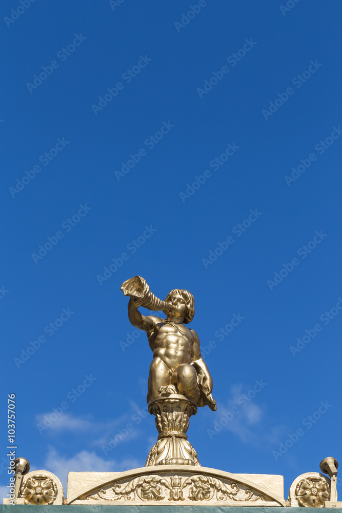 A Gold Cherub Statue against Blue Sky in Nevsky Avenue in St Petersburg, Russia