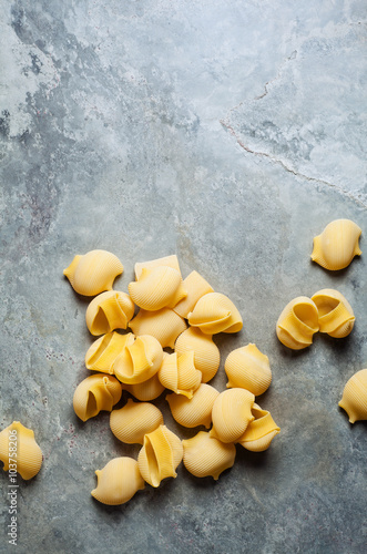 Conchiglie pasta on a gray stone background