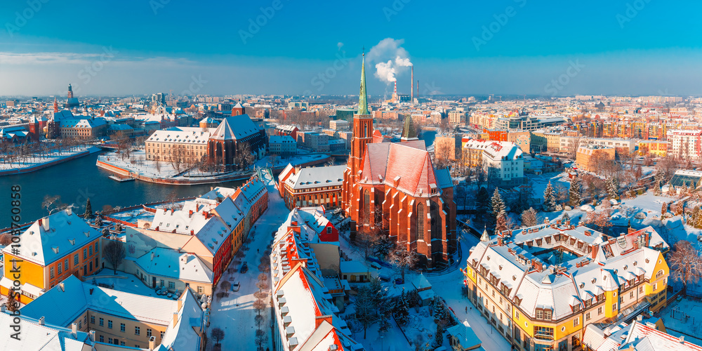 Fototapeta premium Aerial scenic panorama of Old Town and Ostrow Tumski with church of the Holy Cross and St. Bartholomew from Cathedral of St. John in the winter morning in Wroclaw, Poland