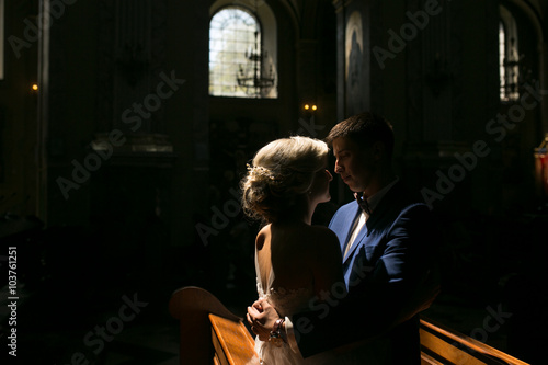 bride and groom illuminated by light