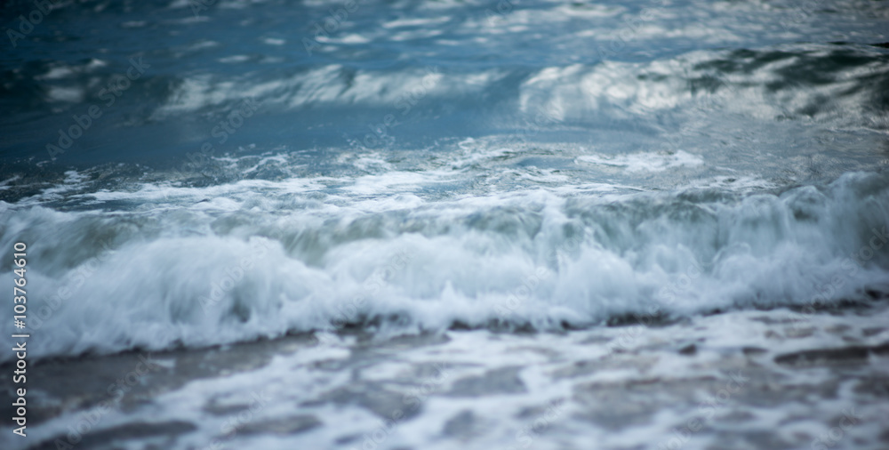 Fototapeta premium Sea wave foam on the pebble beach