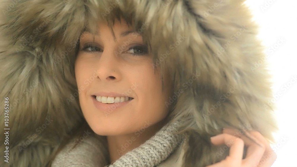 Closeup of woman wearing coat with fur hood, isolated Closeup of woman wearing coat with fur hood, isolated