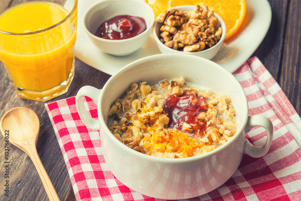 Oatmeal with walnuts, orange peel and jam for breakfast Oatmeal with walnuts, orange peel and jam for breakfast