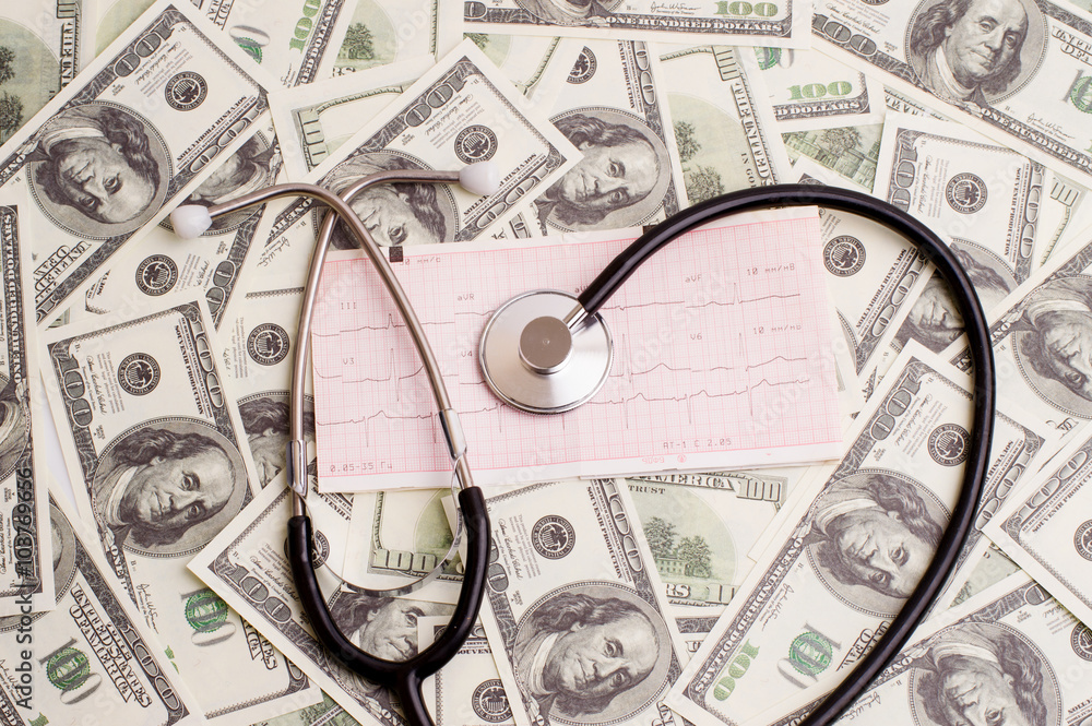stethoscope over ecg graph and 100 dollar bills stethoscope over ecg graph and 100 dollar bills