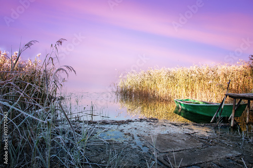 Fototapeta Naklejka Na Ścianę i Meble -  Frosted footbridge with a moored boat. Masuria, Poland.