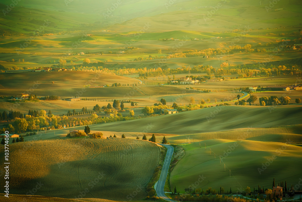 Wavy fields in Tuscany at sunset, Italy. Natural outdoor seasonal spring background.